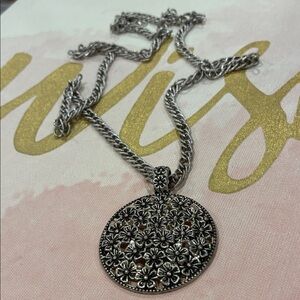 Floral Design Theme Within Circular Silver Tone Pendant Necklace